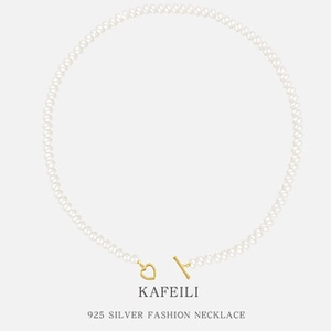 Close-up of S925 silver pearl necklace with a golden heart toggle clasp on grey background