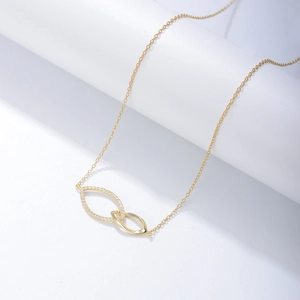 Macro detail of gold-plated double-loop pendant with sparkling pavé cubic zirconia