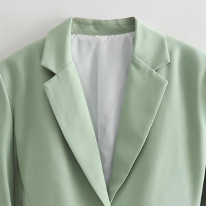 Women's V-neck blazer in light green featuring professional lapels and padded shoulders