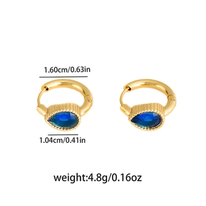 Close-up of gold star earrings with emerald green crystals and size measurements