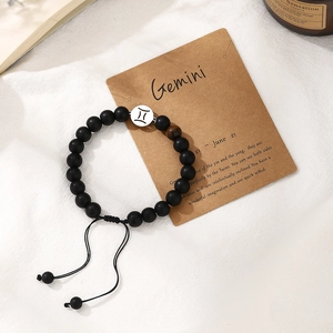 Handmade Gemini zodiac charm bracelet with black beads and adjustable woven cord design