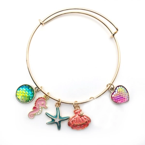 Golden charm bracelet with Summer shell, seahorse, and colorful ocean-themed enamel pendants