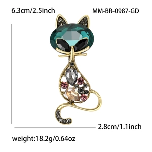 Elegant vintage cat brooch with emerald green gemstone and colorful rhinestones in gold tone