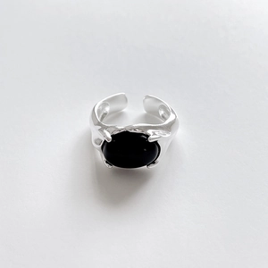 Detailed shot of adjustable silver flower ring with black agate and lava texture