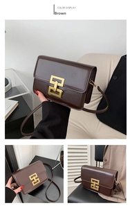 Close-up of brown faux leather crossbody bag with square gold buckle detail