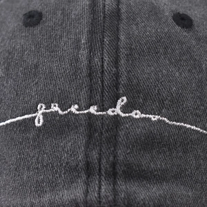 Washed cotton baseball cap in dark gray with freedom embroidery and vintage texture