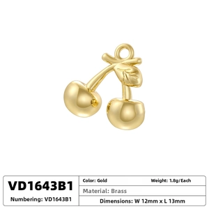 Detail of a 12mm gold cherry pendant charm in polished brass for DIY jewelry making
