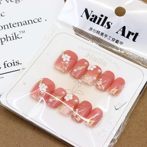 Short peach pink gradient press-on nails with white flowers and small pearls in size M