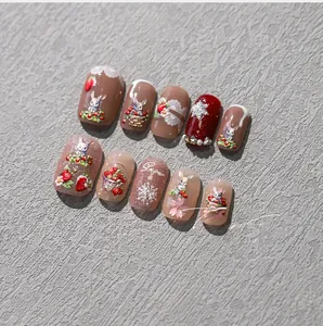 Detailed macro view of 3D embossed nail art featuring rabbit and strawberry motifs