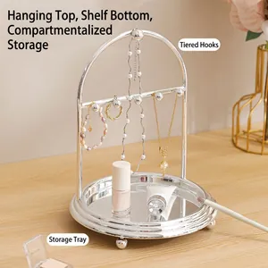 Silver metal jewelry organizer stand with arched tiered hooks and a round tray base