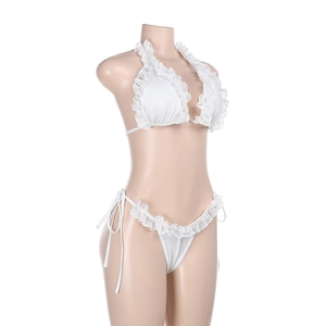 Detail of white ruffled bikini set featuring textured fabric and side-tie bikini bottoms
