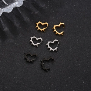 Three pairs of spiked heart hoop earrings in gold silver and black steel finishes