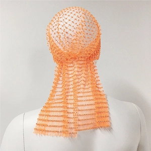 Close-up of orange mesh headpiece featuring sparkling rhinestones and a long trailing tail