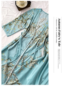 Detail of light blue floral satin kimono robe with elegant gold leaf patterns and tie belt