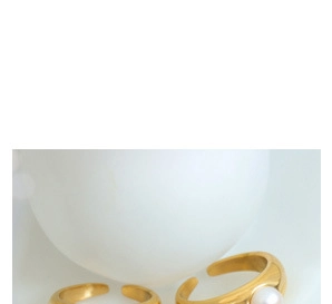 Detail of adjustable gold ring set featuring minimalist bands and small white pearl