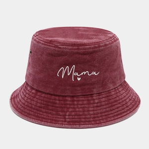 Detail of the white Mama embroidery on a vintage washed burgundy cotton bucket hat