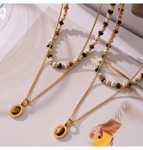 Detail of layered tiger eye stone necklace on fashion magazine with elegant beads