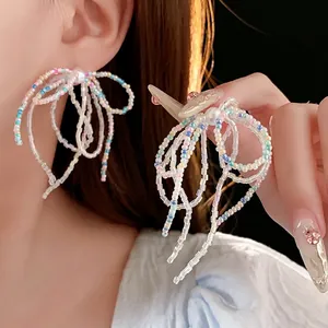 Handcrafted bow drop earrings with iridescent crystal beads and white imitation pearl