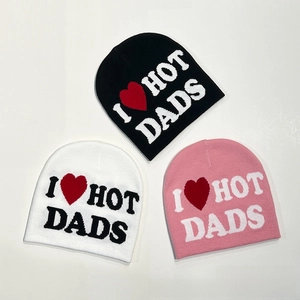Detailed knit texture of beanie featuring I Love Hot Dads slogan with red heart embroidery
