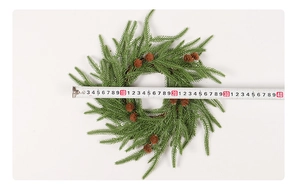 Detail of 30cm pine needle Christmas wreath with natural pine cones and measuring tape