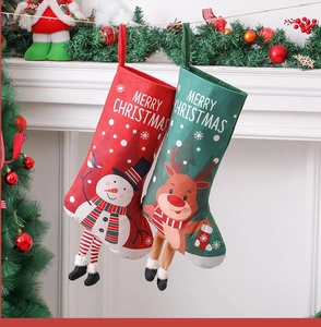 Detail of Christmas stockings with cartoon dolls hanging on a white fireplace mantle