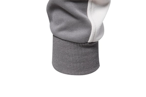 Macro shot of grey and white color-block knit cotton sweatshirt with ribbed cuff details