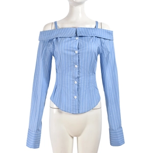 Detail of blue striped off-shoulder shirt showing button closure and folded collar texture