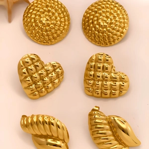 Three pairs of vintage gold geometric earrings in round spiral and heart-quilted shapes
