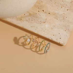 Close-up of S925 silver stamp on gold tulip ring with pearls and green zircon