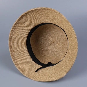 Detailed interior view of a Japanese straw sun hat showing the adjustable strap
