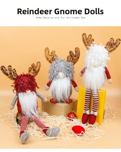Close-up of three festive Christmas gnomes with reindeer antlers and long striped legs