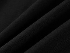 Macro close-up of premium black modal fabric showing breathable twill texture and soft fibers