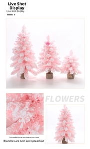 Detailed view of pink flocked mini Christmas trees with faux snow and burlap base