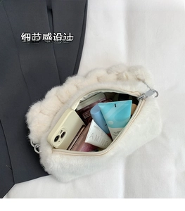 Detail view of the spacious interior of the plush white shoulder bag with items inside