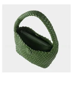 Detailed top view of grass green woven tote bag with matching zippered inner pouch