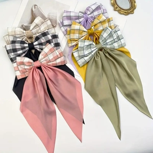 Assorted plaid and solid color satin bow hair clips in multiple vibrant spring colors