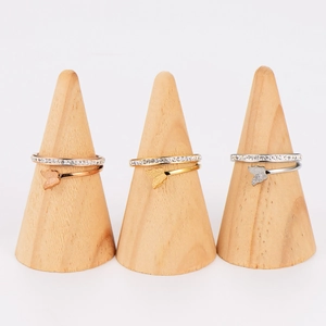 Three minimalist stainless steel butterfly rings in gold, silver, and rose gold finishes