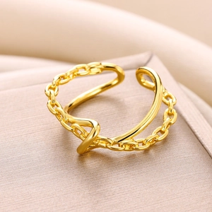 Macro detail of gold-plated double-layer ring featuring a Cuban link and smooth band