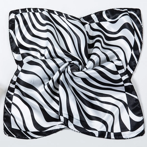 Macro shot of black and white wavy zebra pattern satin scarf with smooth silk texture