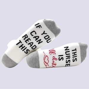 Detail view of cotton socks with printed text If You Can Read This Nurse Is Off Duty