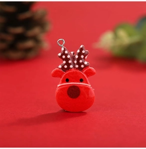 Macro shot of a red reindeer resin ornament with white polka dot antlers and metal ring