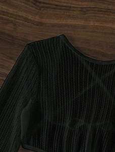 Macro view of black mesh bikini top showing herringbone hollow texture and crew neckline