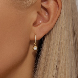 Close-up of elegant S925 silver gold-plated hoop earrings with white pearl drop and zircons