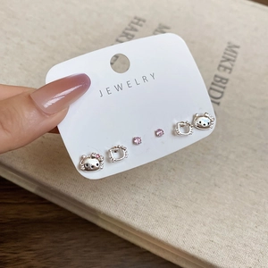 Detailed view of silver Hello Kitty cat stud earrings set with pink zircon accents