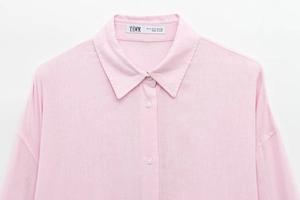 Close-up of pink long-sleeve linen shirt collar and natural fabric texture details