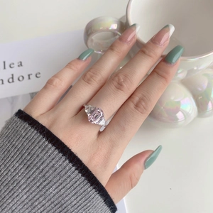 Detail of S925 silver ring featuring pink emerald-cut center stone and side diamonds