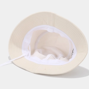 Interior detail of beige canvas bucket hat with breathable mesh lining and adjustable drawstring