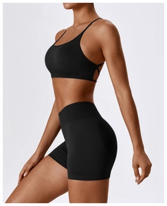Side view of black seamless sports bra and high-waist ribbed fitness shorts for yoga