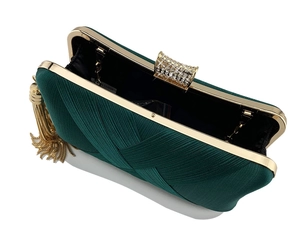 Detail of emerald green satin evening clutch with sparkling rhinestones and gold fringe