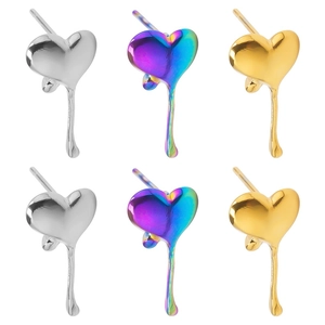Detailed close-up of heart-shaped liquid metal earrings in silver, gold, and rainbow finish
